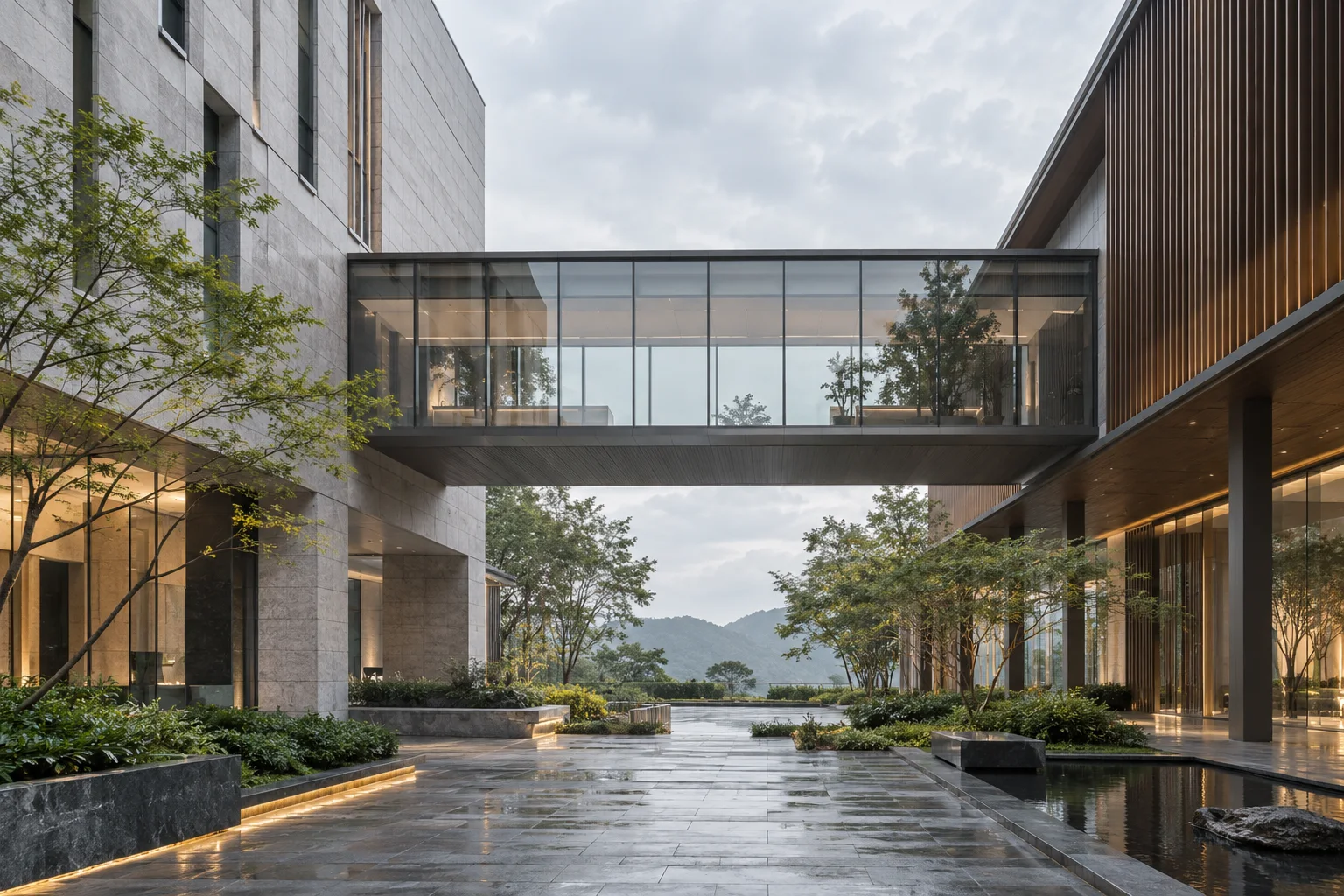 两翼不同材质的建筑通过通透廊桥相连，体量真实克制，以空间关系表达调整与协同